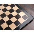 Detailed shot of the 60mm squares and polished finish of the ebony and maple wood chess board.