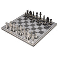 Wide angle view of the 12-inch brass metal luxury chess set showcasing the silver pieces in the foreground.