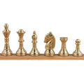 Macro profile of a single gold brass knight piece, showing its intricate Staunton-inspired design.