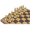 Top-down macro shot of the gold king, queen, and bishops on the ornate copper and gold board.