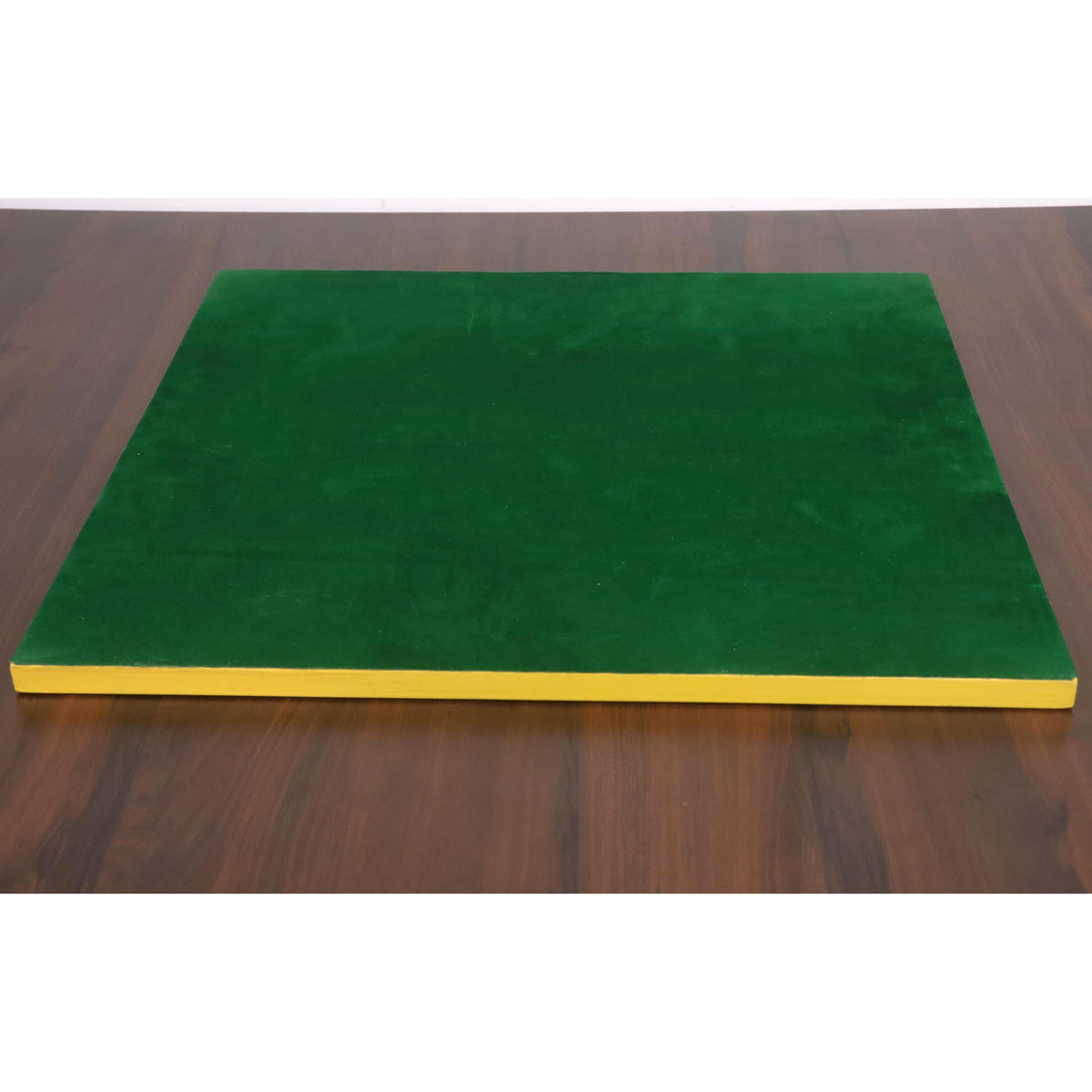 The underside of a wooden chessboard featuring a protective green felt base.