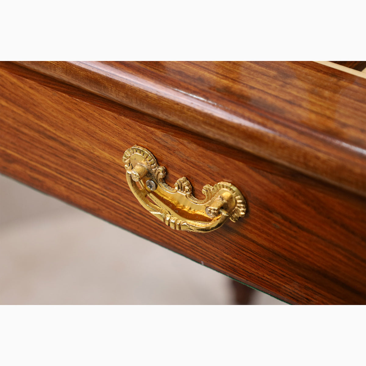 Elegant brass handle on a premium golden rosewood chess table drawer.