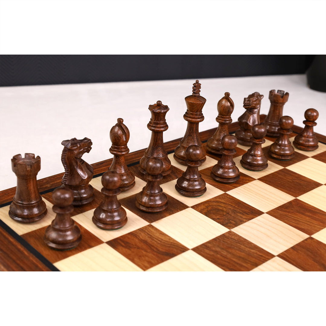 Handcrafted dark golden rosewood chess pieces set up on a wooden tournament board.