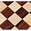 Close-up macro view of contrasting rosewood and maple wood squares.