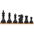 Set of dark ebonised boxwood Staunton chess pieces lined up side by side.