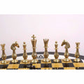 Gold brass chess pieces arranged on a luxury black and gold chess board.