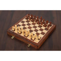10-inch magnetic travel chess set in golden rosewood fully set up on a luxury wooden table.
