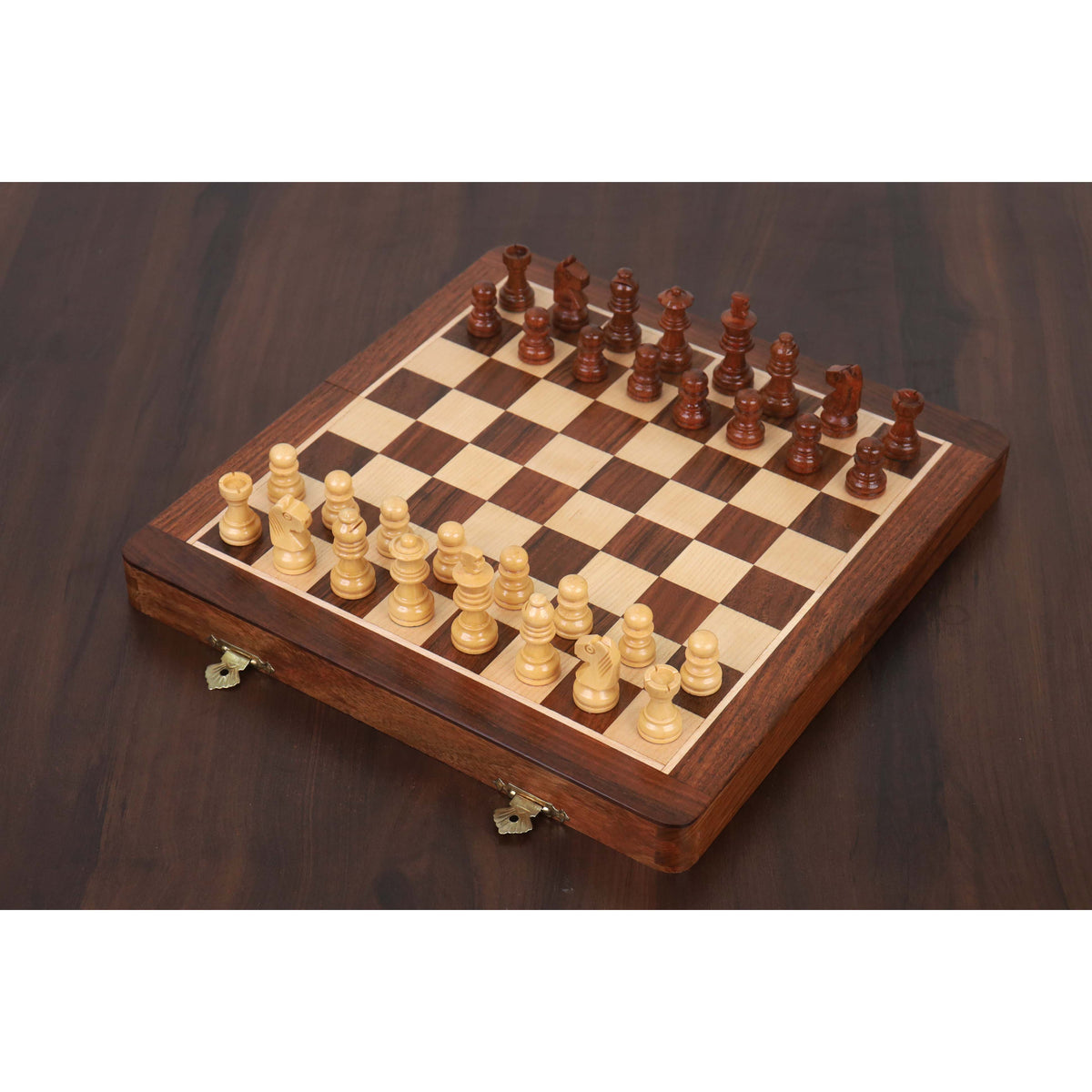 10-inch magnetic travel chess set in golden rosewood fully set up on a luxury wooden table.