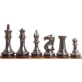 Polished grey brass chess pieces in Staunton style.