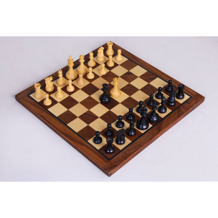 Full set of ebonised boxwood Staunton chess pieces set up on a 12-inch magnetic travel chess board.