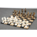 Complete animal kingdom series chess pieces set in white and antiqued camel bone arranged on a board.