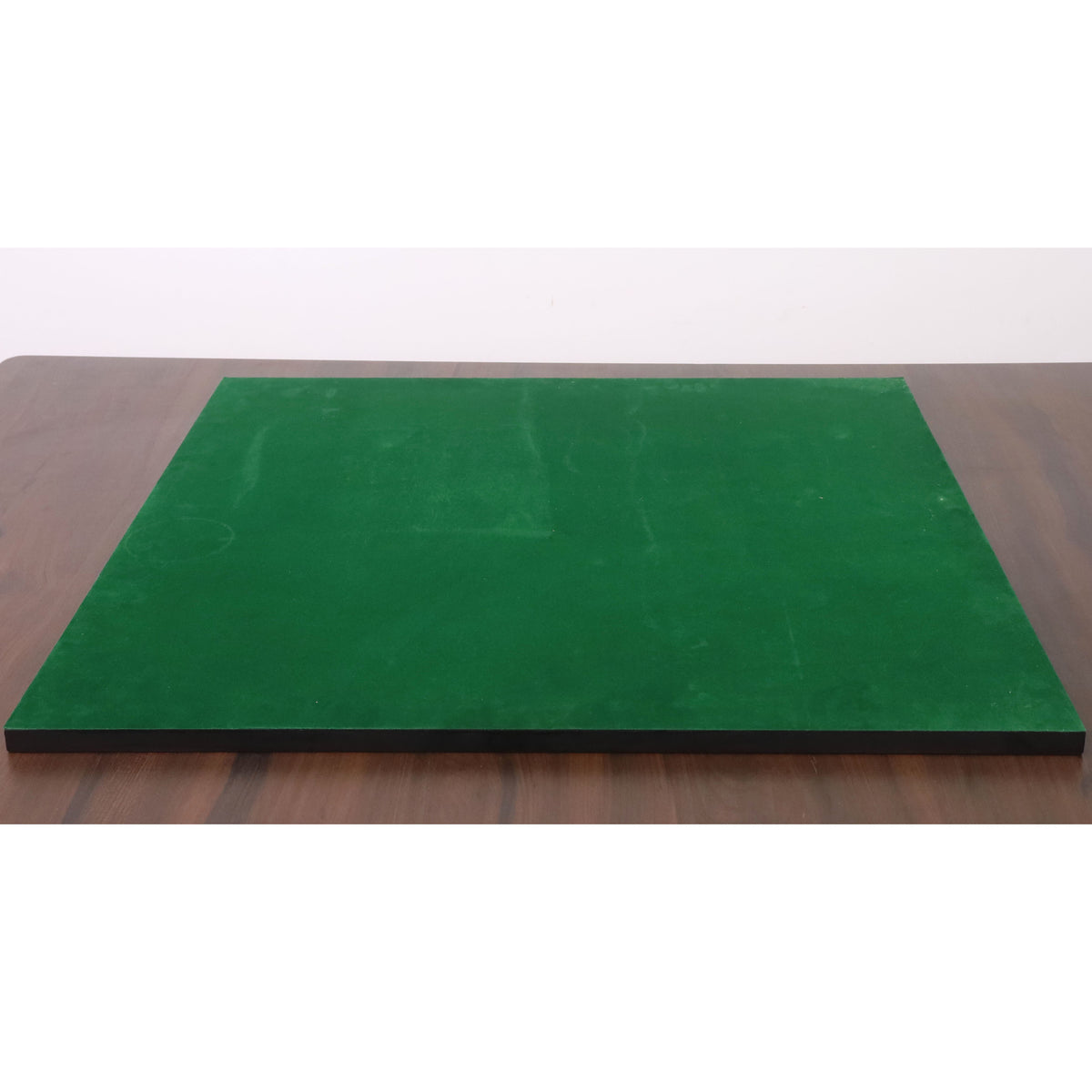 Bottom view of a chess board featuring a full green felt base to prevent scratches on furniture.