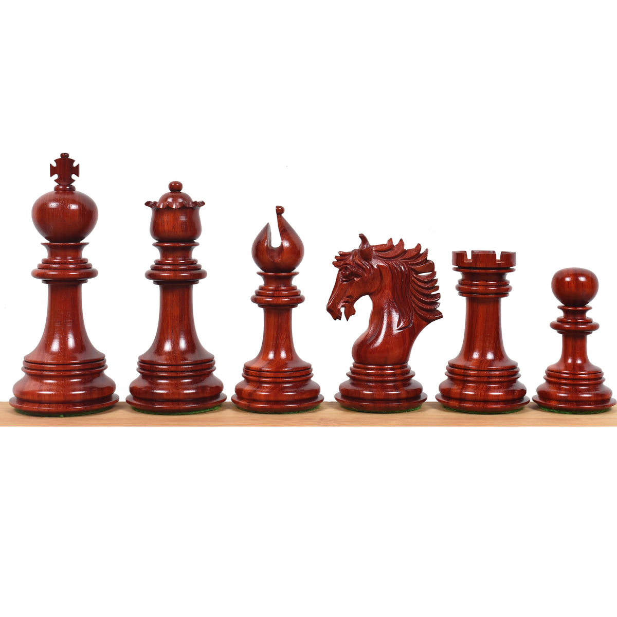 Full side profile lineup of the rich crimson bud rosewood Arthur Staunton chess pieces displaying premium polish.