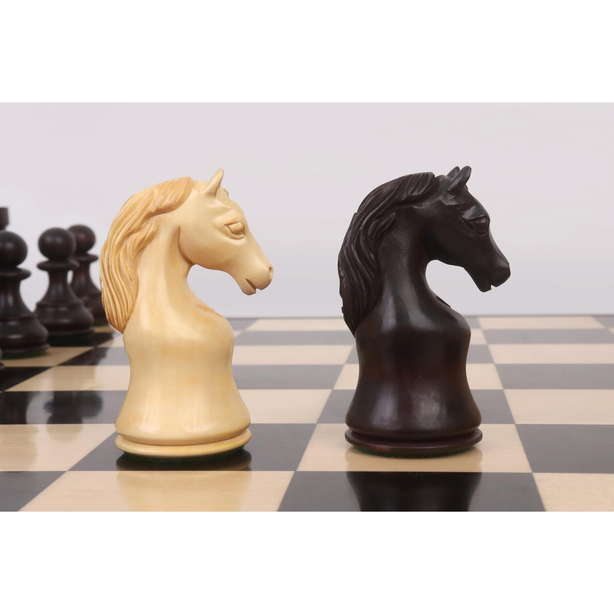 Detailed side-by-side view of light boxwood and mahogany-stained Piatigorsky Cup chess knights.