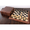 Edinburgh upright chess set arranged on a wooden board next to its luxury brown leather storage case.