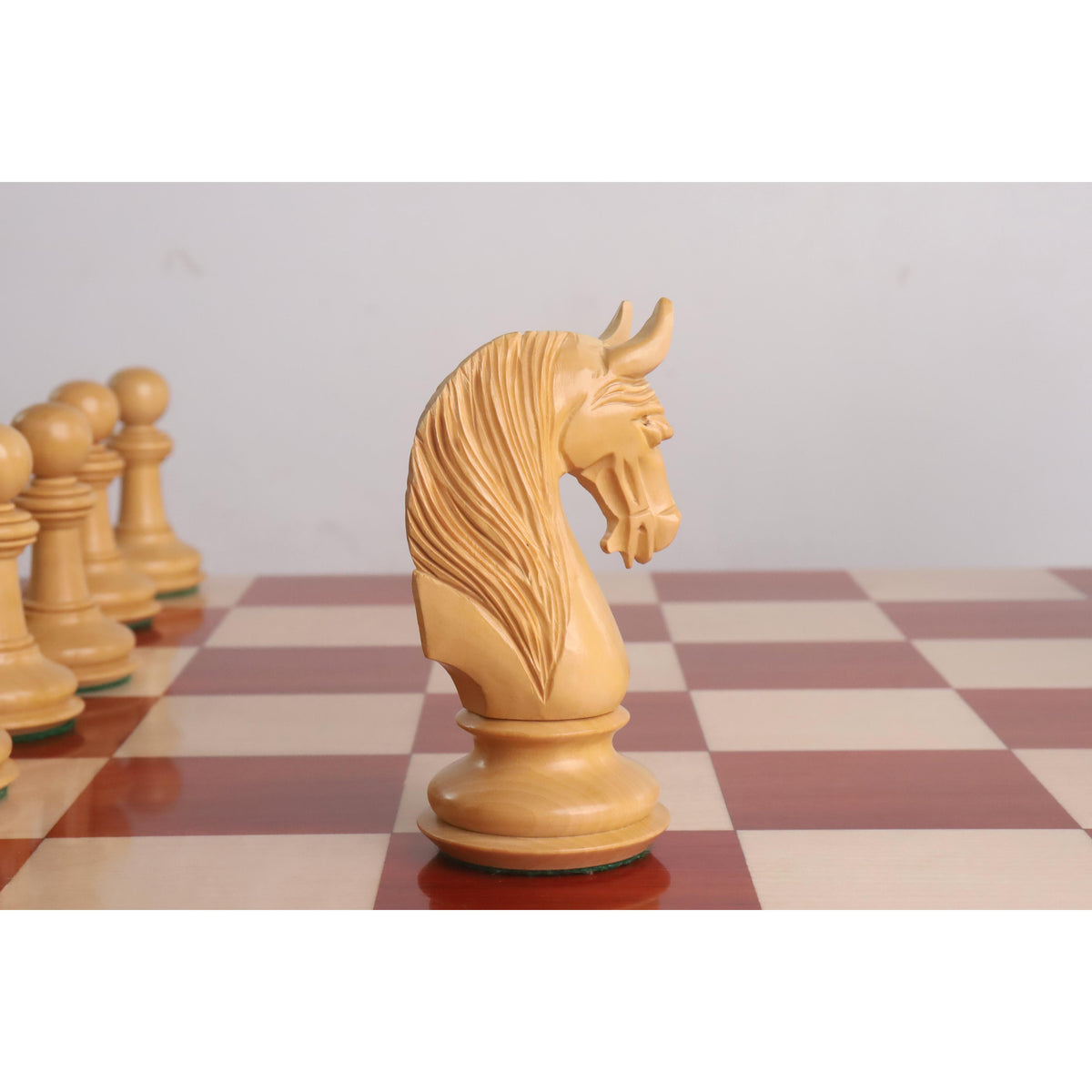 Side view of the intricately hand carved boxwood knight from the Bath luxury Staunton chess pieces.