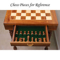 Interior of the chess table drawer lined with green felt, showing organized storage for dark wood chess pieces.