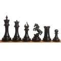 High-end ebony wood Incitatus luxury Staunton chess pieces neatly lined up on a smooth wooden base.