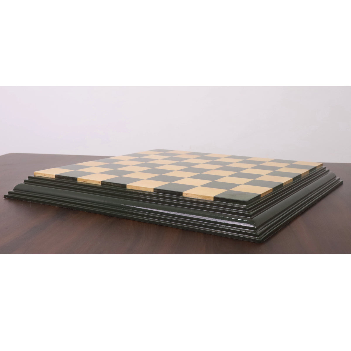 Profile view showing the thick, tiered decorative edge of the green and maple HDMR chess board.