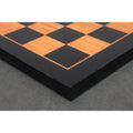 Corner detail of a professional 21 inch wooden chess board showing the 55mm square size and ebony border.