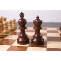 Close-up of the elegant rosewood Taj Mahal Staunton King and Queen pieces on a chessboard.
