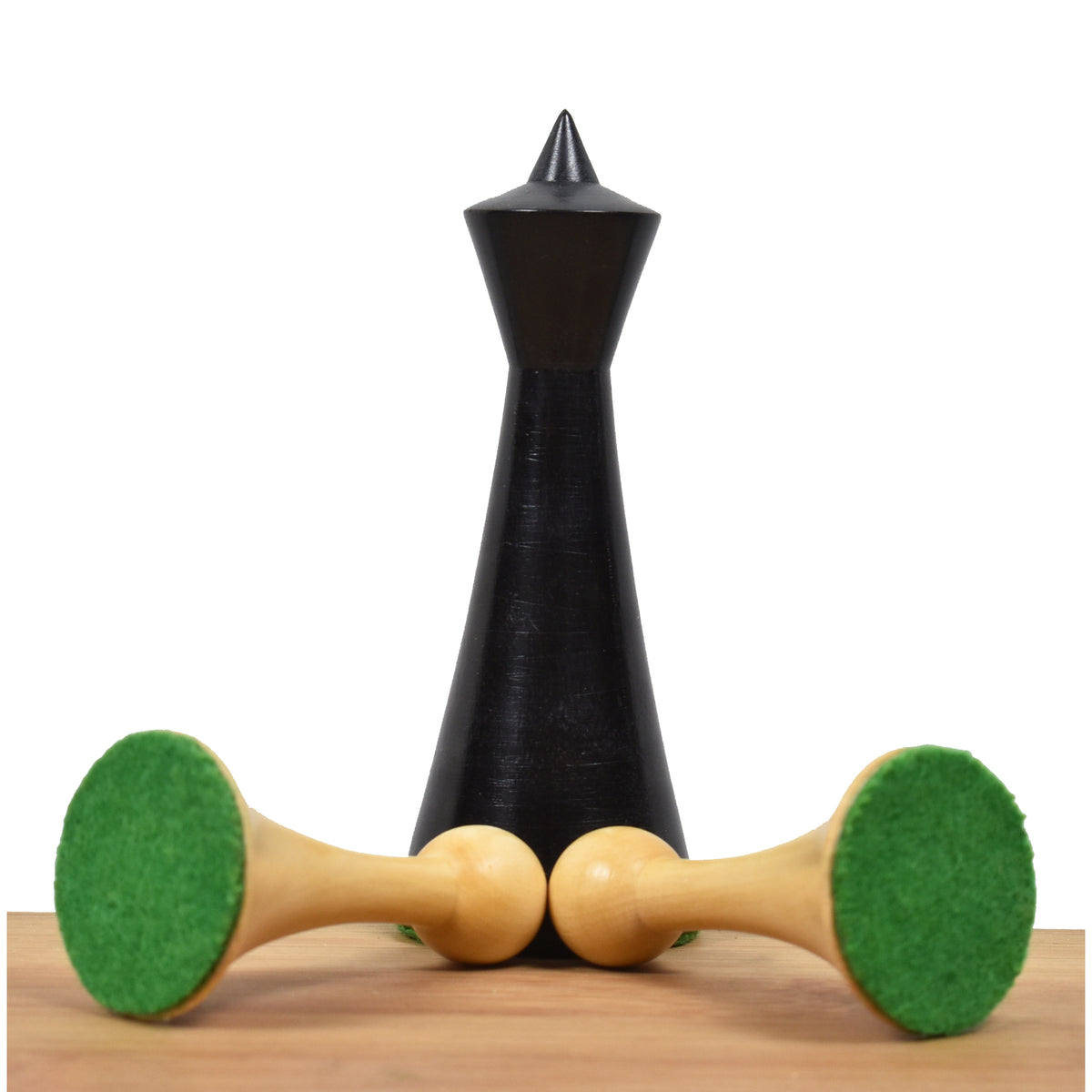 Close-up of an ebonized Herman Ohme queen standing behind two natural boxwood pawns.