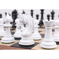 Close-up of a white texture painted Staunton Knight standing among other white chess pieces on a board.