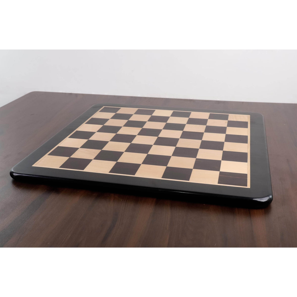 Low-angle side view of the 21" solid wood chess board highlighting its thick, sturdy profile.