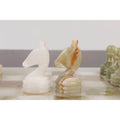 Detailed white and green marble knight chess pieces side-by-side.
