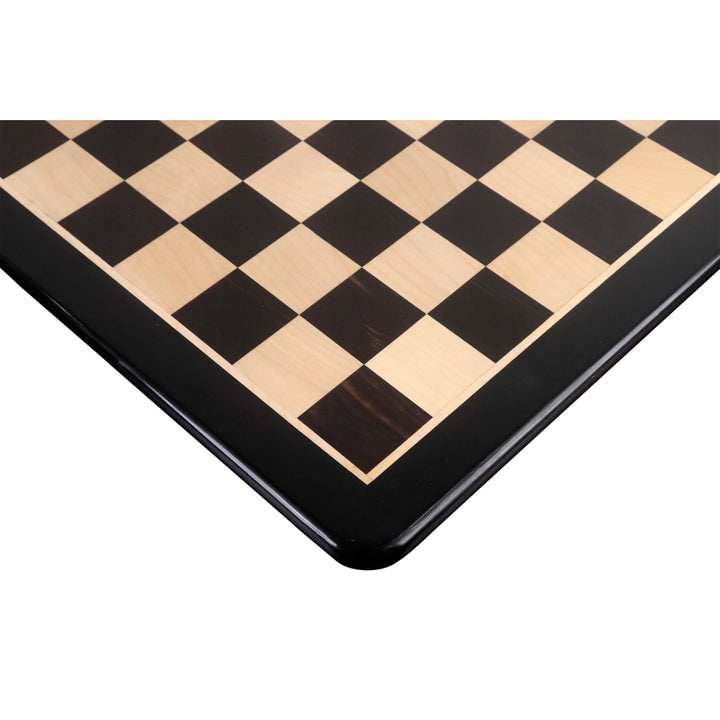 Corner detail of a 21-inch ebony and maple wood chessboard with a matte finish.
