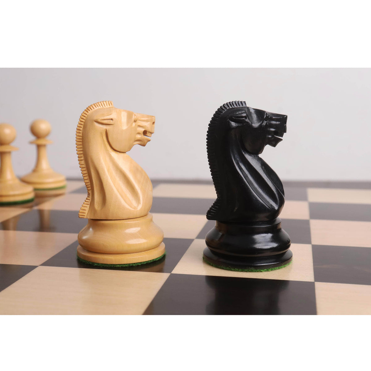 Detailed carving on boxwood and ebony knights from the 19th century reproduced luxury chess set.
