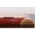 Close-up profile of a luxury chessboard featuring a green felt base and bud rosewood border.