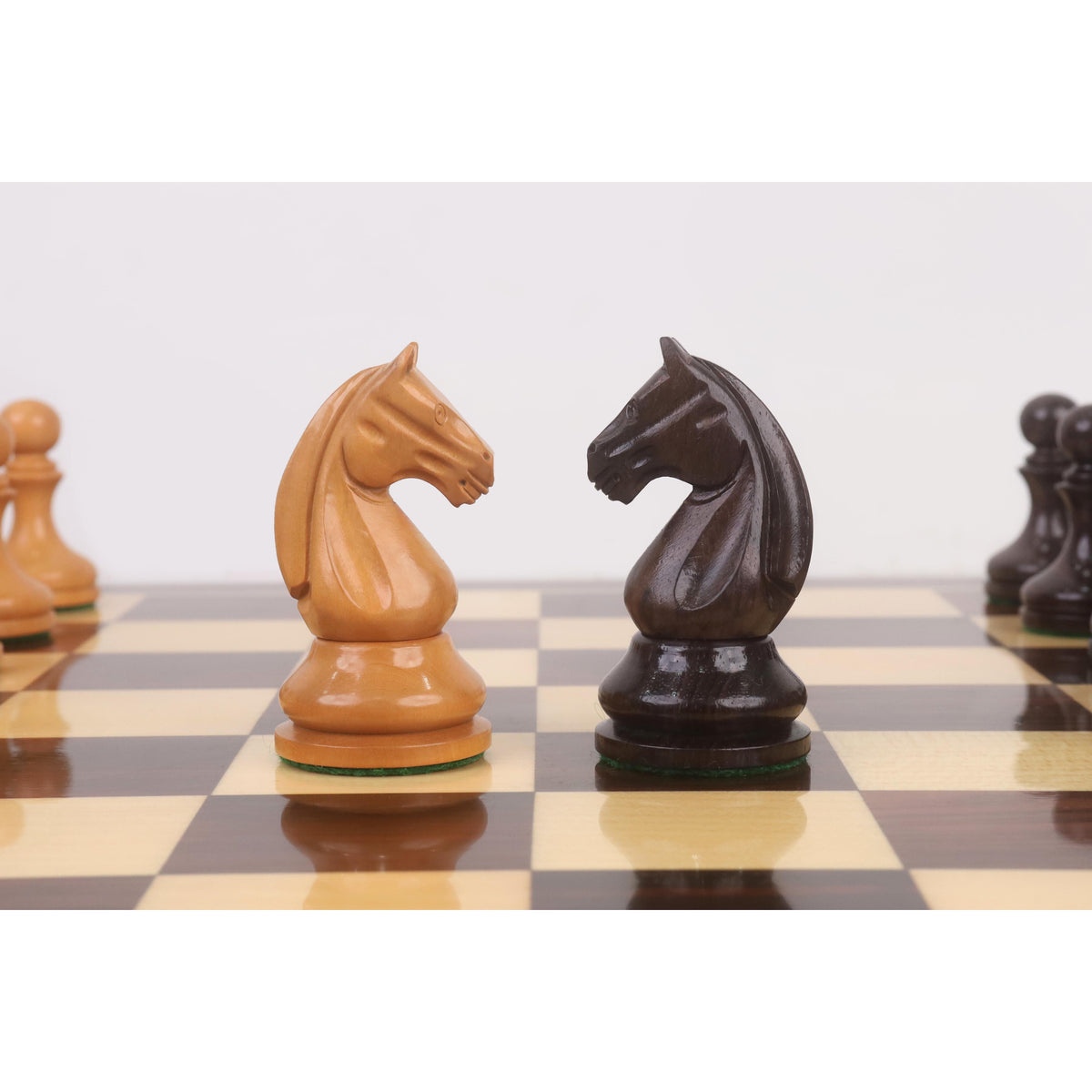 Side profile of facing antiqued boxwood and rosewood knights from the 3.8" Candidates Series minimalist chess set.