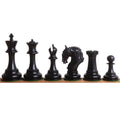 Polished ebony wood Imperator luxury Staunton chess pieces displayed in a straight line.