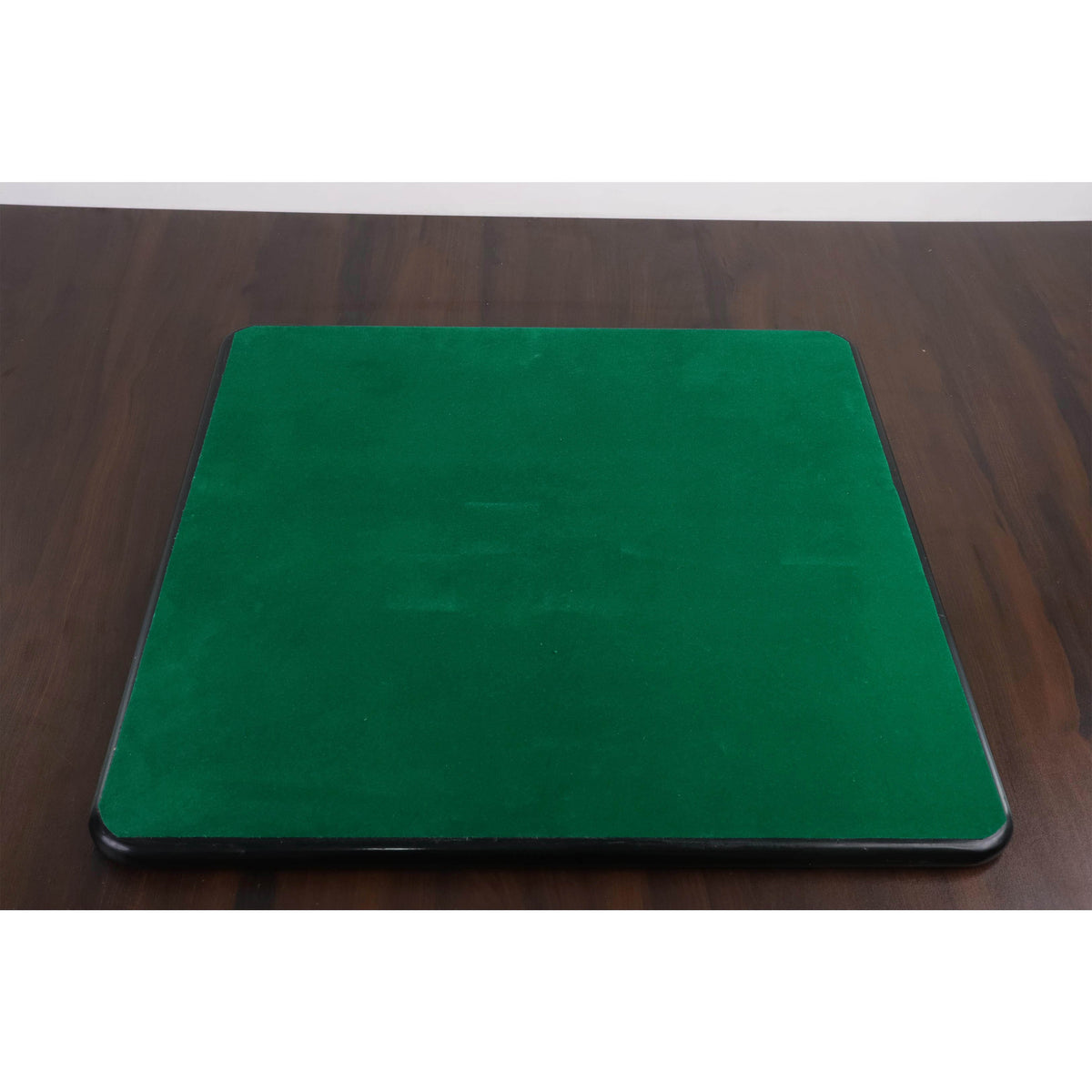 Underneath view of a chessboard featuring a green felt backing for surface protection.