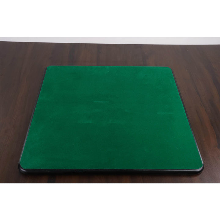 Underneath view of a chessboard featuring a green felt backing for surface protection.