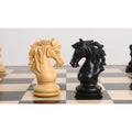 A close-up shot of identical Goliath Series Knights in contrasting Ebony and Boxwood wood, facing each other on a checkered board.