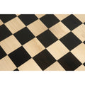 Grid pattern of a handcrafted ebony and maple wooden chessboard.