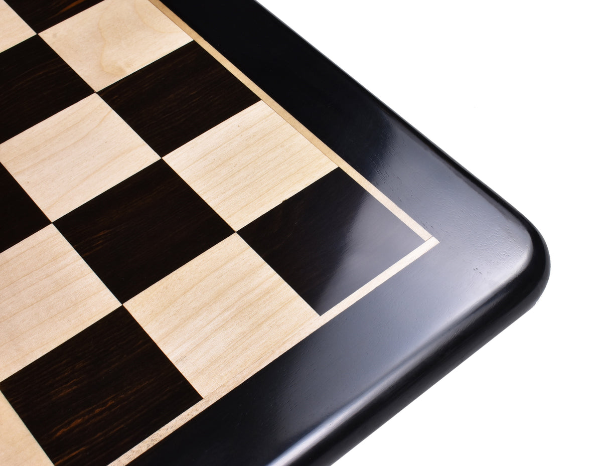 An angled view of a polished wooden chessboard corner with a premium high-gloss finish.