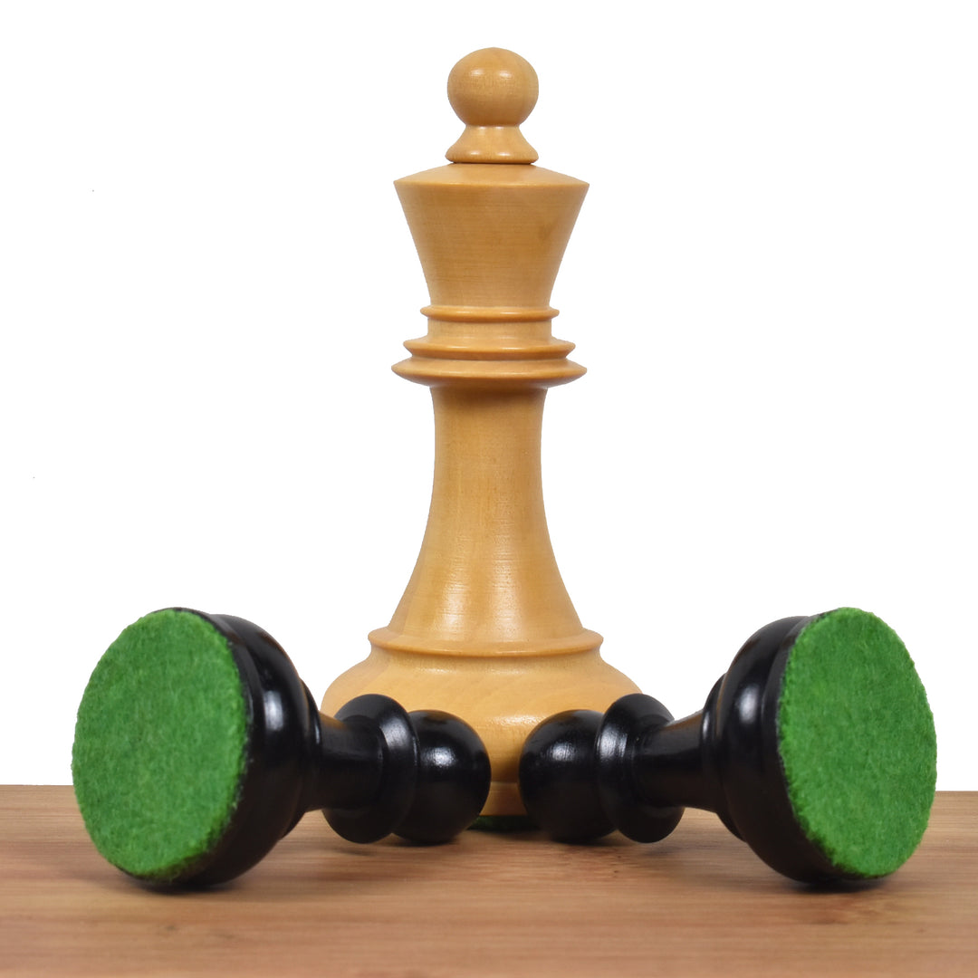 Bottom view of double weighted 1970s Dubrovnik chess pieces highlighting the green billiard felt base.