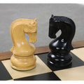 Two detailed knights, in ebonised boxwood and natural boxwood, from the Leningrad Staunton chess set.