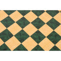 Top-down view of a green and natural ash burl wooden chess board.