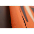 Detailed texture of the handcrafted orange leatherette material and stitching.