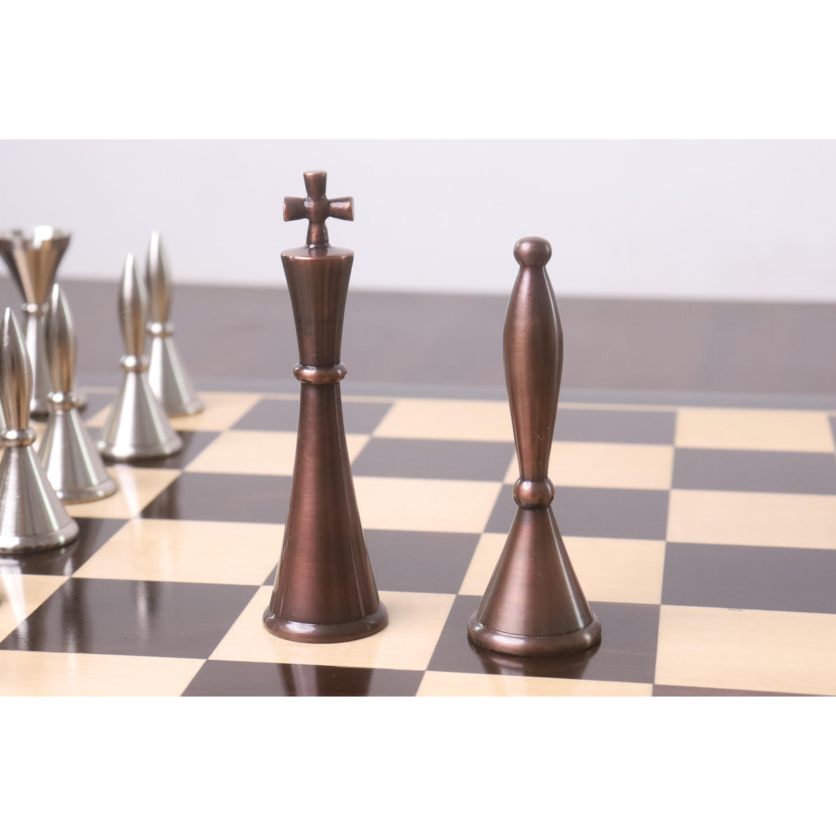 Detailed view of the antiqued copper King and Queen chess pieces.