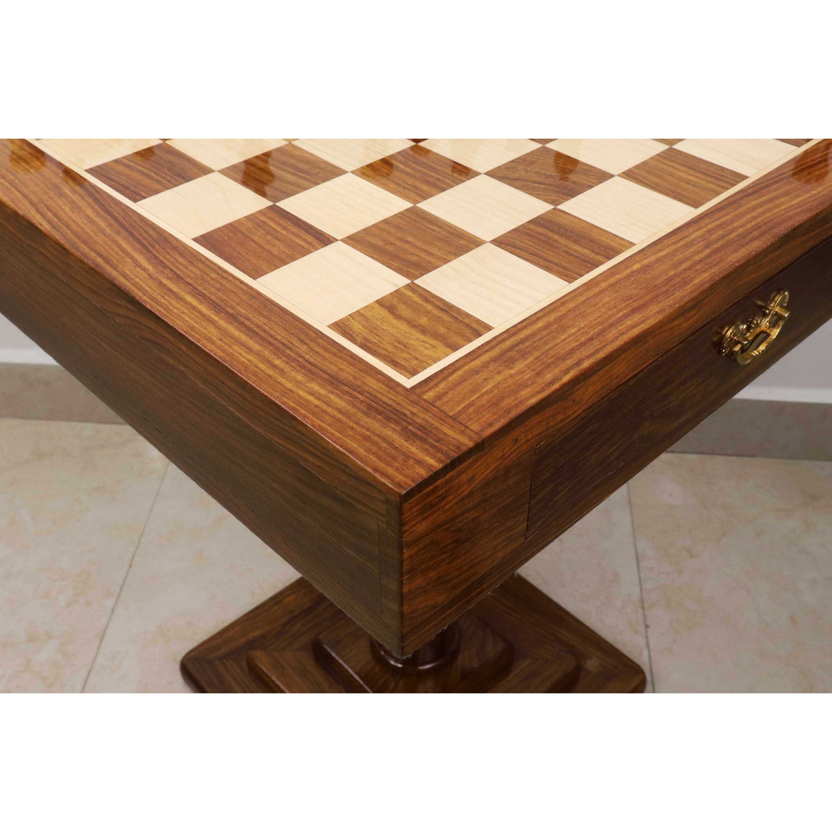Detail of the brass hardware and inlaid maple border on the Monarch chess table.