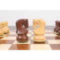 Close-up of intricately carved Russian Zagreb Knights in golden rosewood and boxwood on a game board.