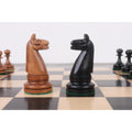 Detailed 1900s American reproduction chess knights facing each other on a wooden board.