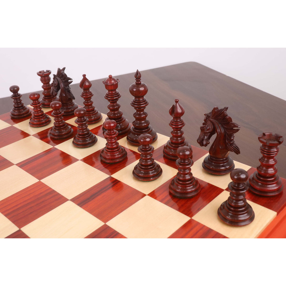 Set of dark Bud Rosewood Staunton chess pieces on the board.