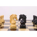 Handcrafted boxwood and ebony Heritage Series Staunton knights facing each other on a chess board.