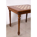 Close-up low-angle view of the intricate turned legs on the Golden Rosewood chess table.